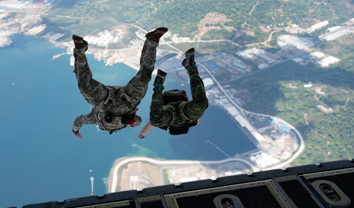 Two Philippines soldiers leap from an MC-130J Commando II above Subic Bay during Balikatan 24 (Sarah Gottschling/US Air Force)