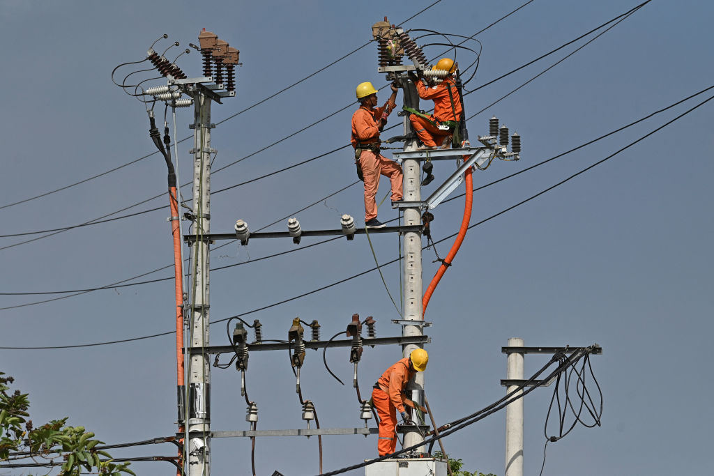 Installing electricity lines in Hanoi (Nhac Nguyen/ AFP via Getty Images)
