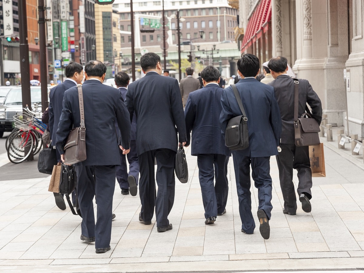 Group of salarymen walking together in the Nihombashi financial district, Tokyo, Japan. (Photo by: Alex Segre/UCG/Universal Images Group via Getty Images)