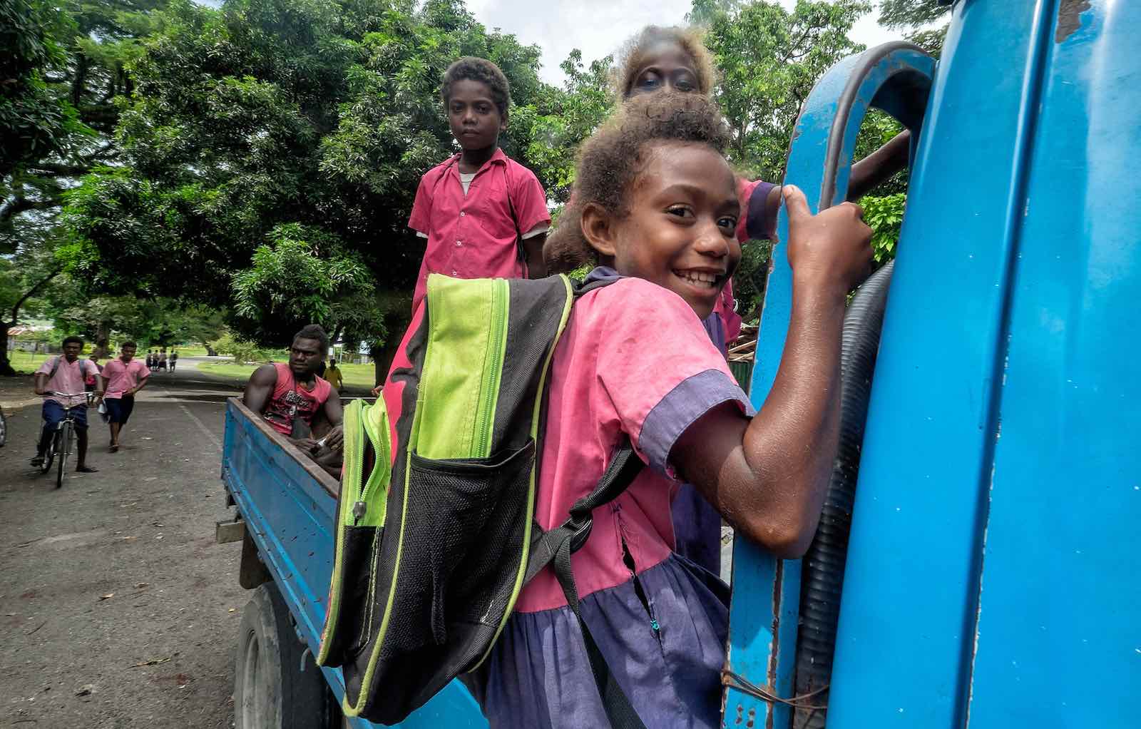Students riding a truck in Honiara, Solomon Islands, where roads were reconstructed and relocated for climate change adaptation (Photo: ADB/Flickr)
