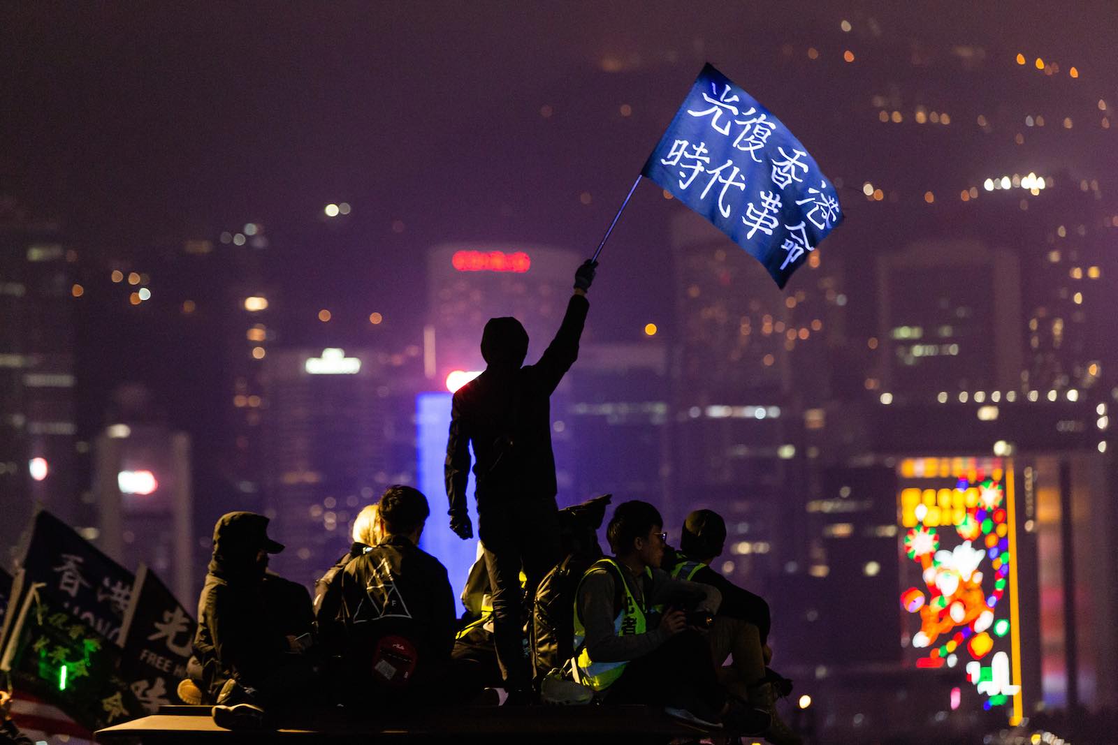 A protester waves a "Liberate Hong Kong" flag during demonstrations in December (Willie Siau via Getty Images)