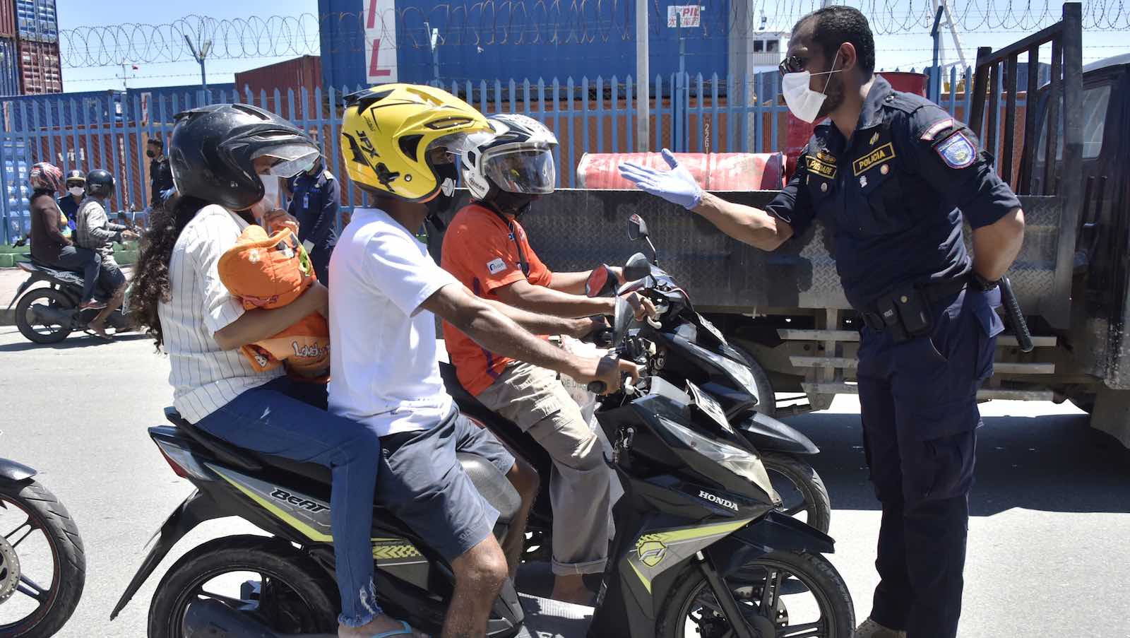 A policeman in Dili asks motorists to carry only one person per bike to ensure social distancing amid Covid-19 concerns (Valentino Dariell De Sousa/AFP/Getty Images)