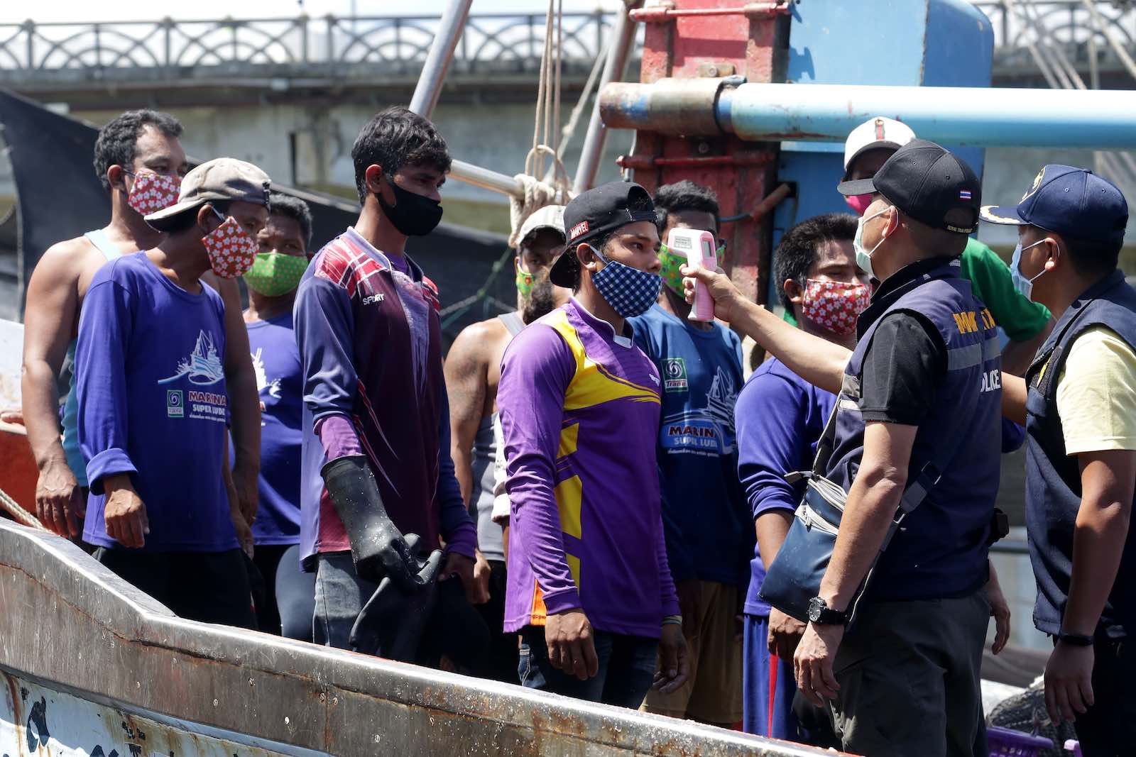Checking the temperatures of Myanmar fisherman on the Thai border (Tuwaedaniya Meringing/AFP/Getty Images)