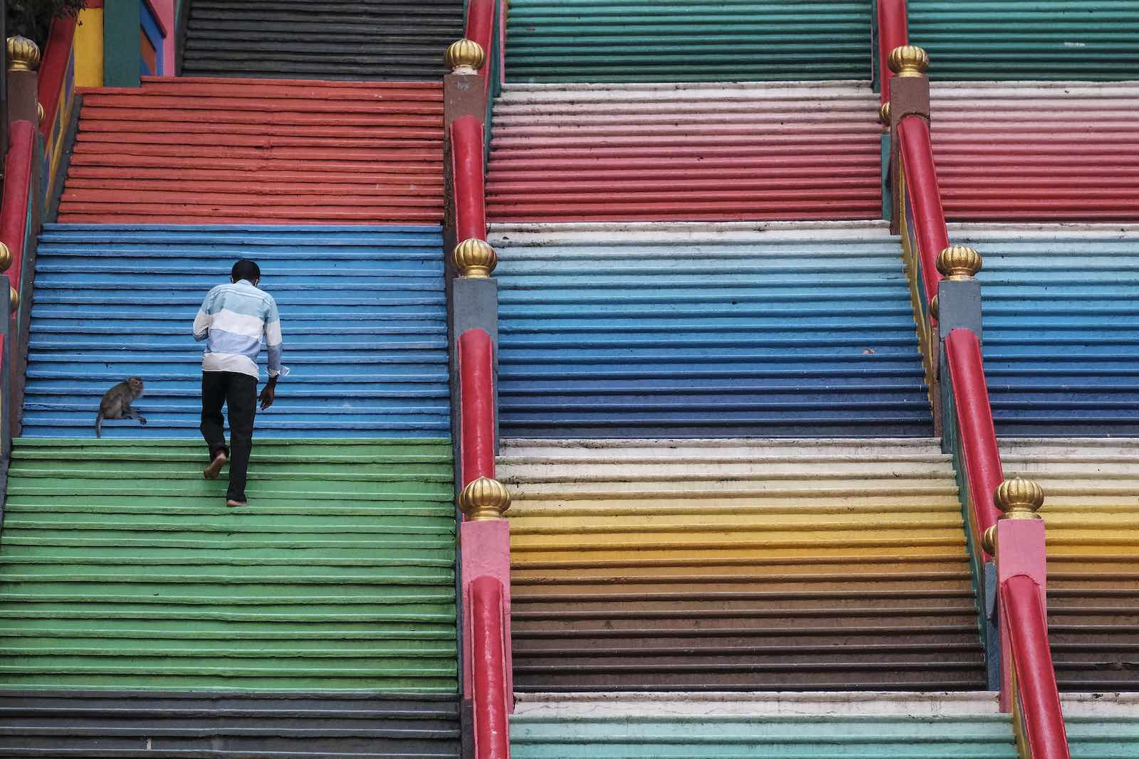 Climbing the stairs leading to the Sri Subramaniar Swamy temple at Batu Caves, Malaysia. Tourism has taken a big hit during the pandemic (Faris Hadziq via Getty Images)