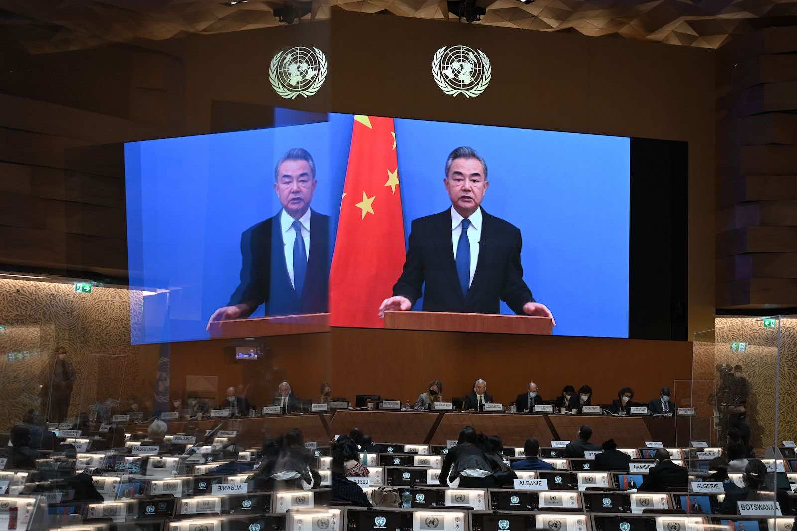 China’s Foreign minister Wang Yi delivers a remote speech at the opening session of the UN Human Rights Council following the Russian invasion in Ukraine, in Geneva, 28 February (Fabrice Coffrini/AFP via Getty Images)