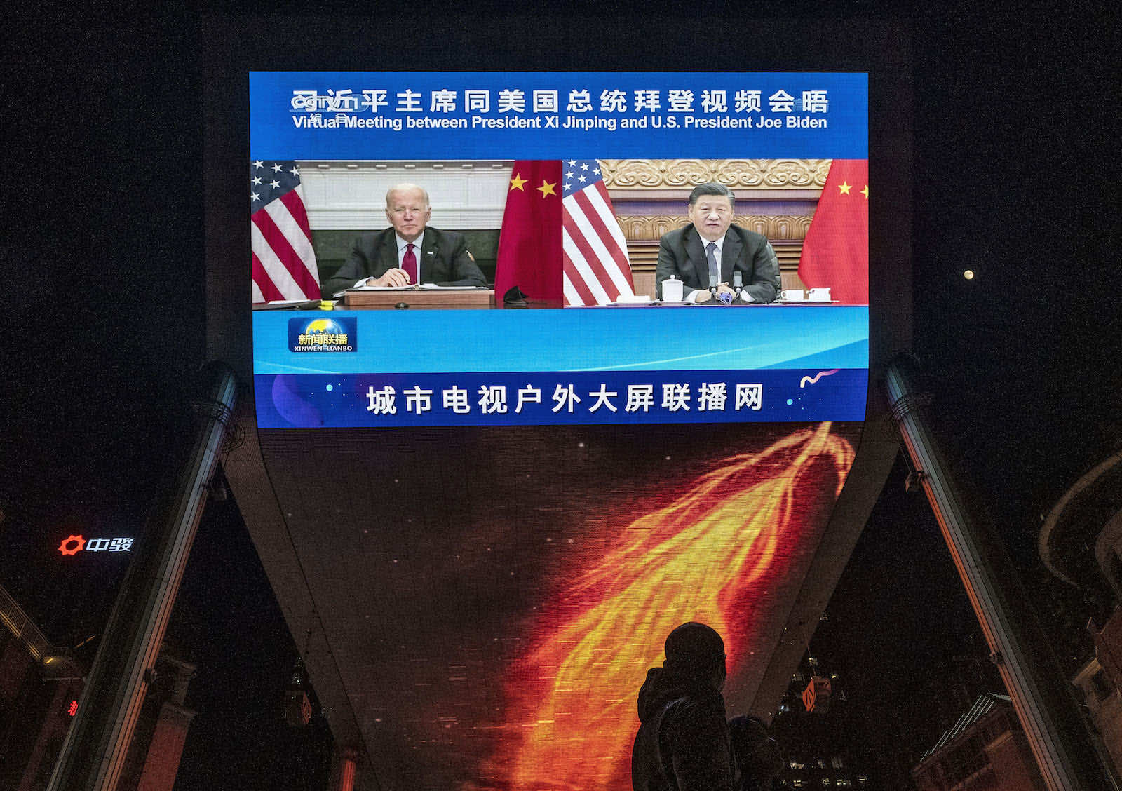 A large outdoor screen in Beijing displays United States President Joe Biden, left, and China’s President Xi Jinping during their virtual summit in November (Kevin Frayer/Getty Images)