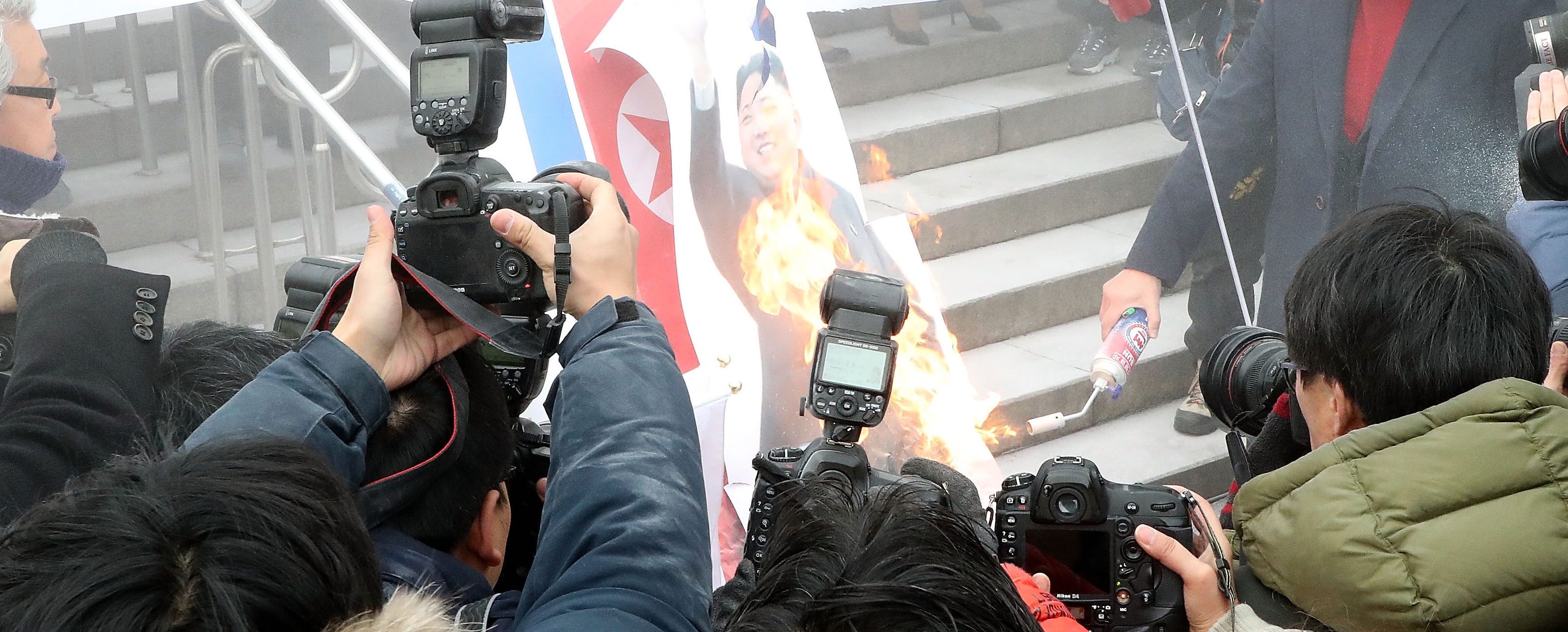 Protesters burn a portrait of North Korean leader Kim Jong-Un in Seoul (Photo: Kim Jae-Myeong/Getty)