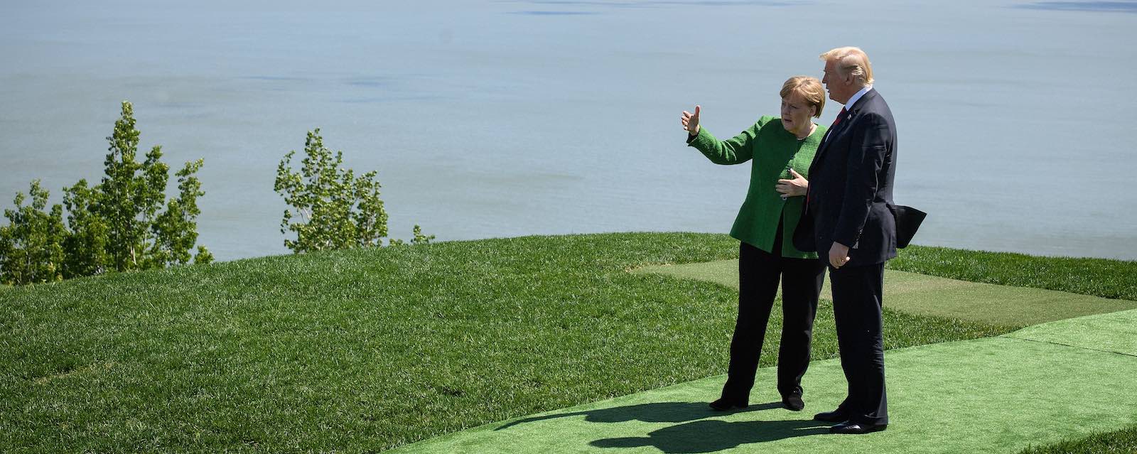 German Chancellor Angela Merkel and US President Donald Trump speak at the G7 Summit in Canada, (Photo: Leon Neal/Getty)
