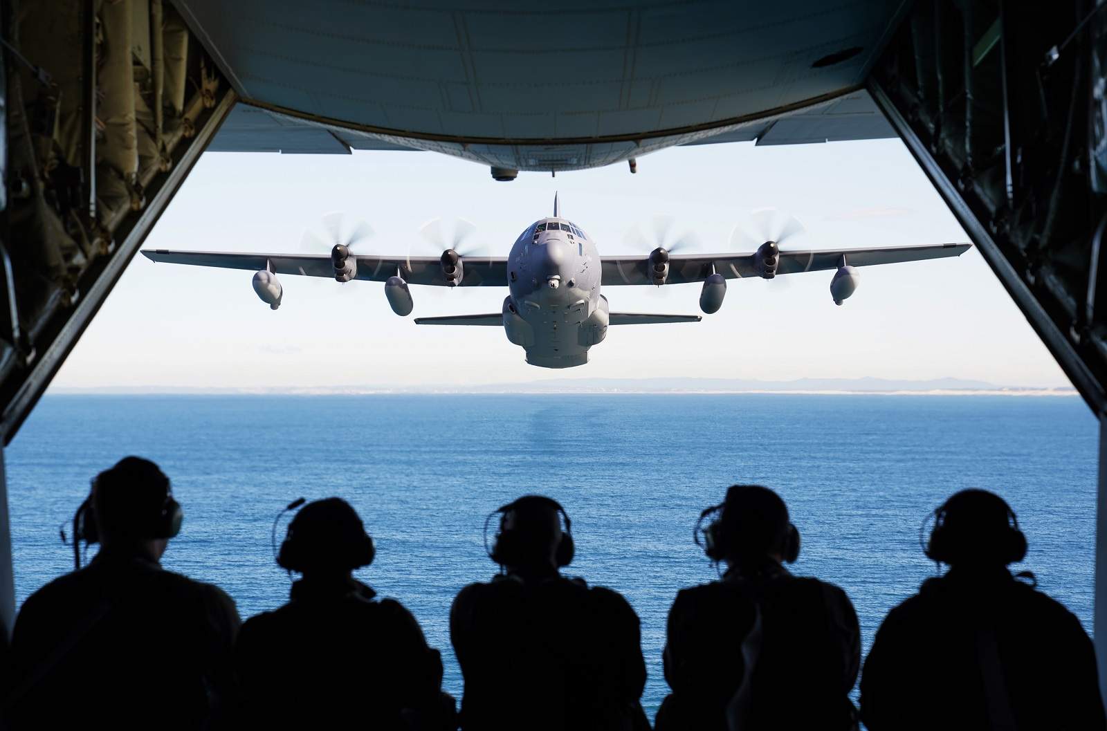 US and Royal Australian Air Force personnel observe an MC-130J Air Commando II flying in formation off the coast of New South Wales, Australia, 3 July 2021 (Joshua Thompson/US Air Force/Flickr)