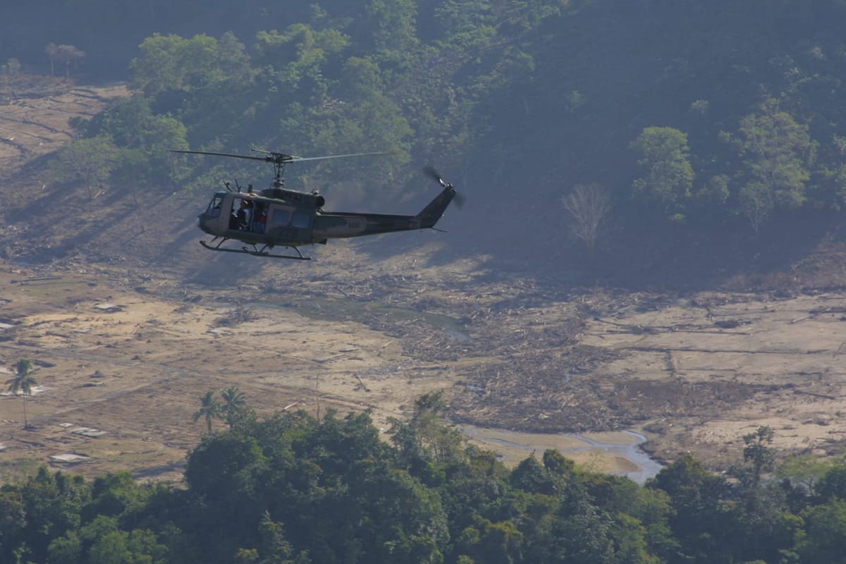 An Australian Army Iroquois helicopter surveys damage on the western coast of the Indonesian province of Aceh following the 2004 tsunami (Cameron Jamieson/Department of Defence)