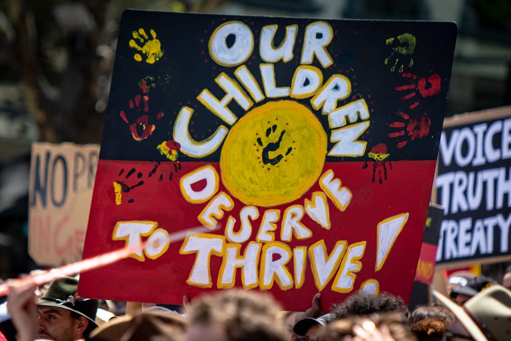 Demonstrators drawing attention to Indigenous rights campaigns in Australia (Andrew Arch/Flickr)