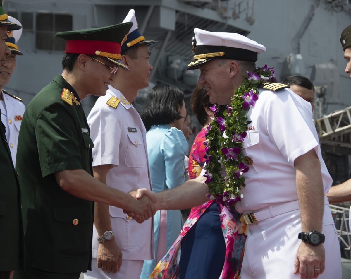 Captain Daryle Cardone, commanding officer of the  USS Ronald Reagan, greets sailors from the Vietnam People’s Navy in Da Nang, Vietnam, 25 June (Keyly Santizo/US Navy)