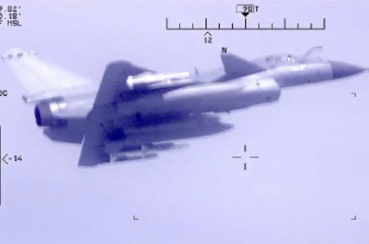 A photo released by the US Department of Defense shows a Chinese air force plane carrying out a risky interception