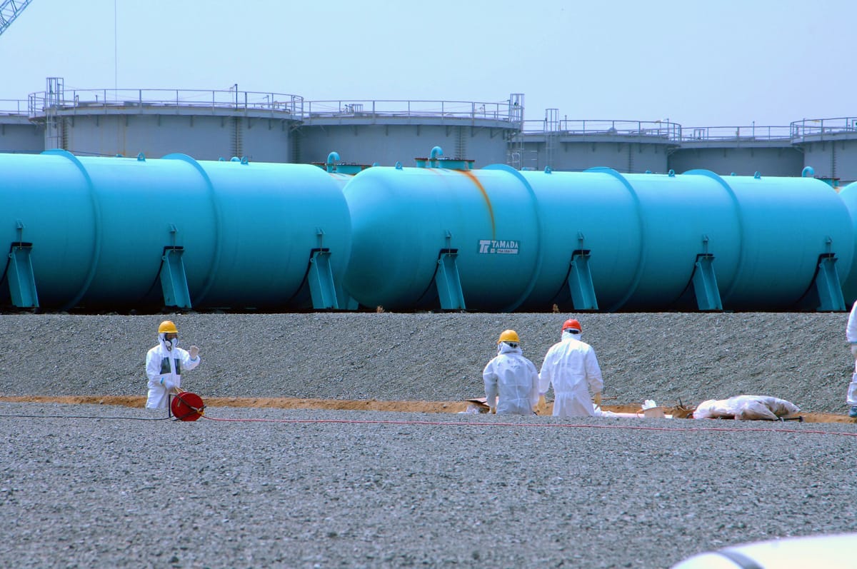 Working among the above-ground storage tanks at the damaged Fukushima Daiichi nuclear power station in 2013 (Greg Webb/IAEA)