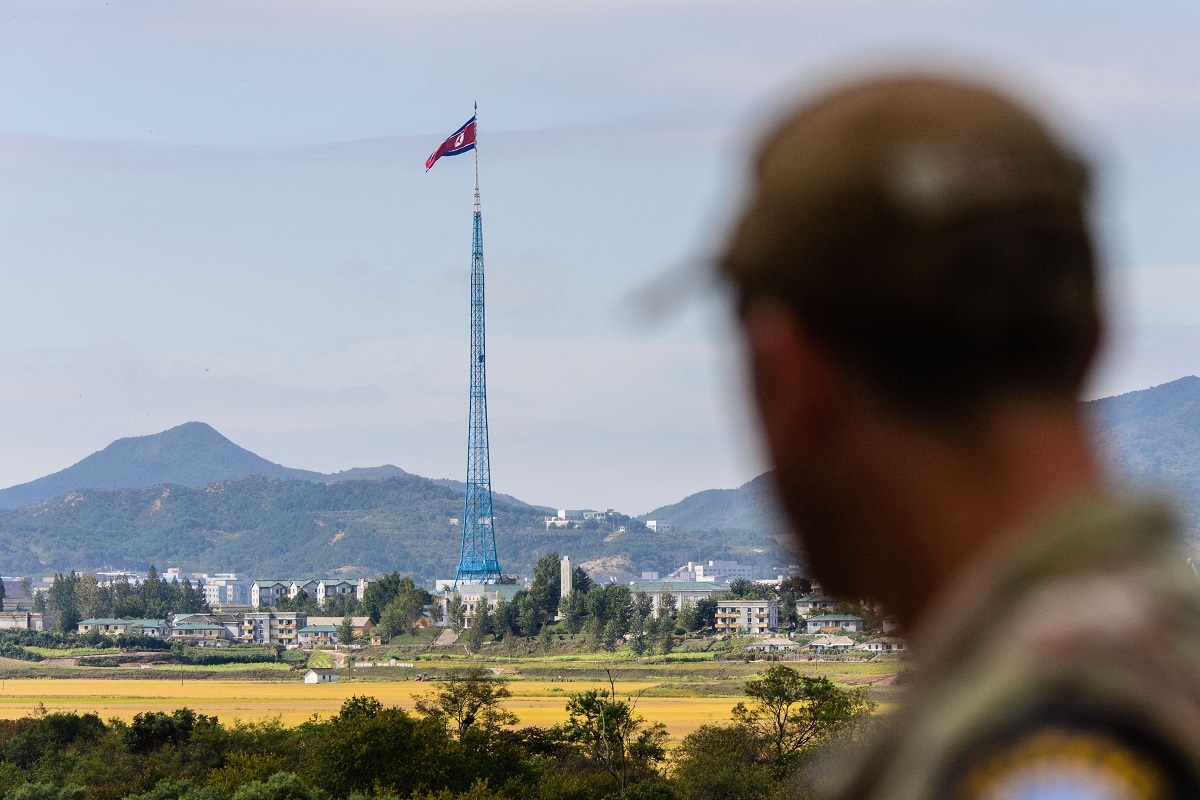 TOPSHOT - A United Nations Command (UNC) soldier looks at a view of North Korea near the truce village of Panmunjom inside the demilitarized zone (DMZ) separating the two Koreas, on October 4, 2022. - North Korea fired a mid-range ballistic missile on October 4, which flew over Japan, Seoul and Tokyo said, a significant escalation as Pyongyang ramps up its record-breaking weapons-testing blitz. (Photo by ANTHONY WALLACE / AFP) (Photo by ANTHONY WALLACE/AFP via Getty Images)