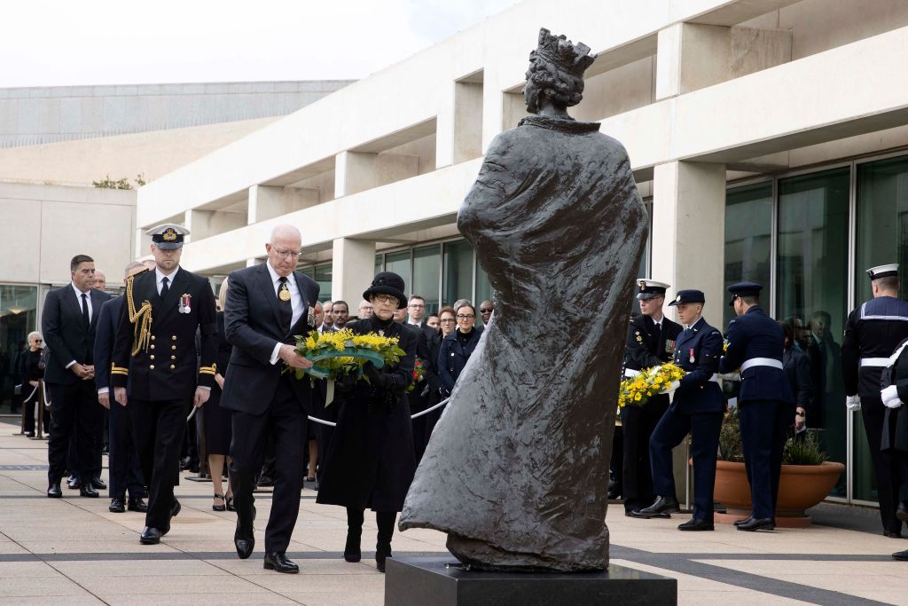 Australia's Governor-General David Hurley (centre left) and his wife Linda Hurley (centre right) lay a wreath at the statue of Britain's Queen Elizabeth II at Parliament House in Canberra (Gary Ramage/AFP via Getty Images)