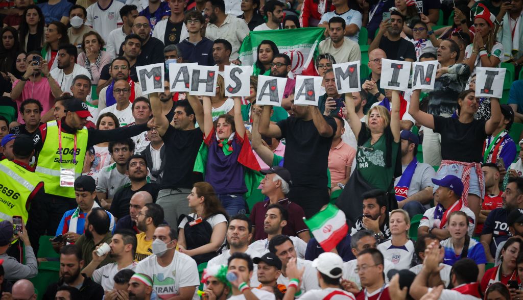 Iranian supporters at the game between Iran and USA hold letters forming the name Mahsa Amini, the Iranian women who died after being detained by security services in Tehran in September and has become a symbol of regime defiance (Virginie Lefour via Getty Images)