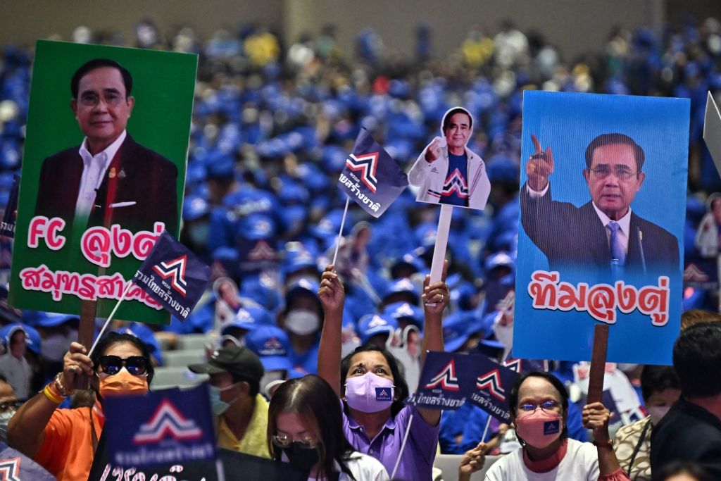 Supporters for the United Thai Nation Party hold placards of Thai prime minister Prayut Chan-O-Cha at a rally in January (Lillian Suwanrumpha/AFP via Getty Images)