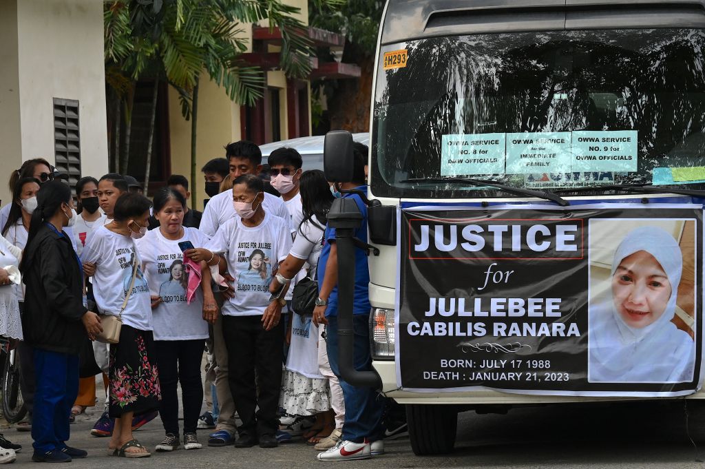 Relatives of Jullebee Ranara grieve during her funeral on 5 February at a cemetery in Las Pinas, Metro Manila. Police recovered Ranara's burnt remains in the Kuwaiti desert and later arrested the 17-year-old son of her employers (Jam Sta Rosa/AFP via Getty Images)