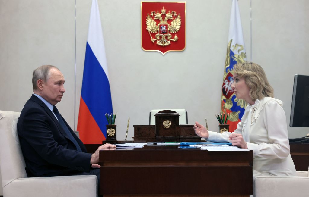 Russian President Vladimir Putin meets with Maria Lvova-Belova, Russian children's rights commissioner, at the Novo-Ogaryovo state residence, outside Moscow, in February. Both have since been indicted by the International Criminal Court (Mikhail Metzel/Sputnik/AFP via Getty Images)