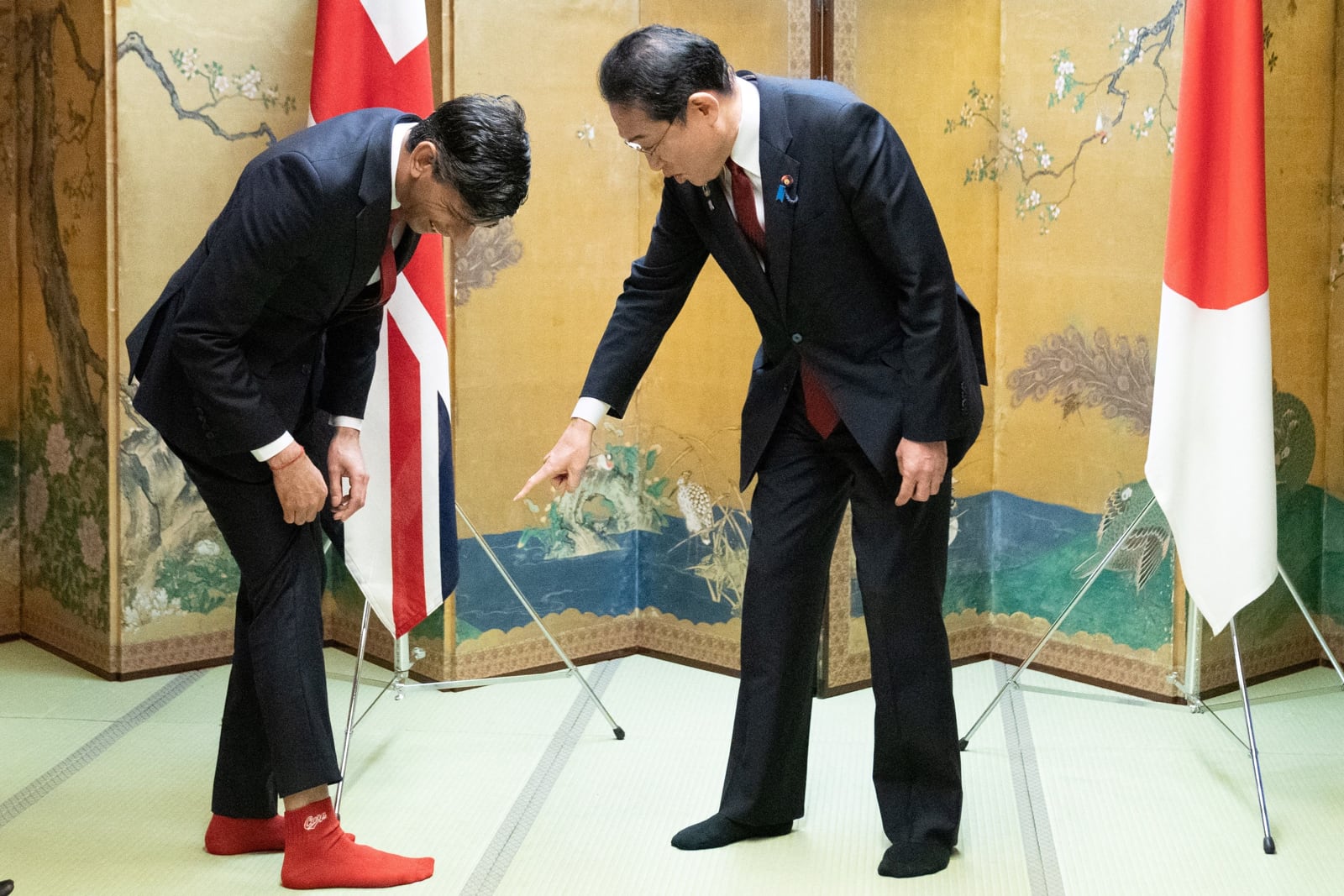 Britain's Prime Minister Rishi Sunak shows off his socks to Japanese Prime Minister Fumio Kishida (Stefan Rousseau/AFP via Getty Images)
