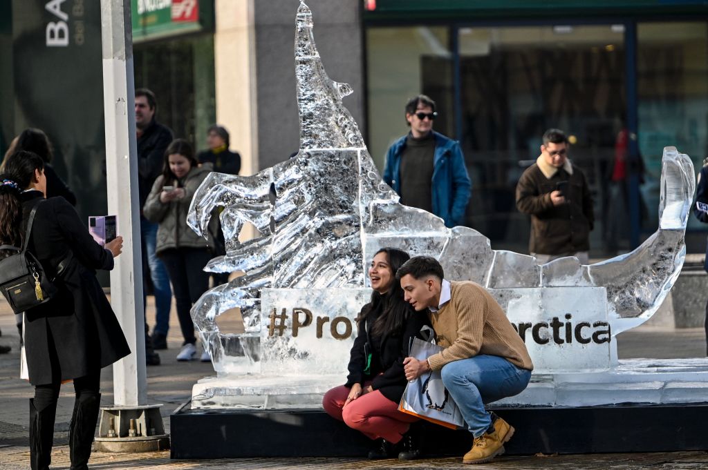 Passers-by pose for a snapshot with an giant ice sculpture of a krill in Santiago last month outside a special meeting of the Commission for the Conservation of Antarctic Marine Living Resources (Martin Bernetti/AFP via Getty Images