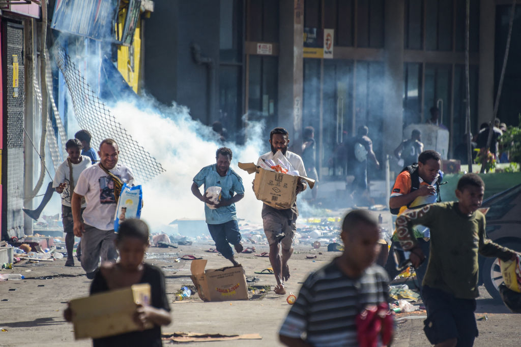 Looting amid a state of unrest in Port Moresby on 10 January (Andrew Kutan/AFP via Getty Images)