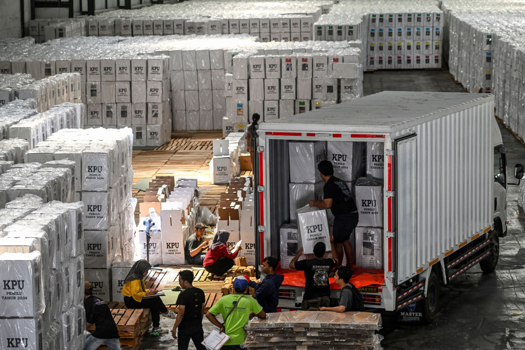 Workers load ballot boxes containing ballot papers onto a truck for distribution to sub-districts at a warehouse of the General Election Commission (KPU) in Surabaya, Java (Juni Kriswanto/AFP via Getty Images)