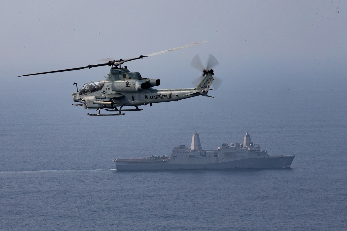 BAY OF BENGAL (April 5, 2021) - A U.S. Marine Corps AH-1Z assigned to Marine Medium Tiltrotor Squadron 164 (Reinforced), 15th Marine Expeditionary Unit, flies over the amphibious transport dock ship USS Somerset (LPD 25) during La Perouse 2021. USS Somerset is part of the Makin Island Amphibious Ready Group with embarked 15th MEU operating in the U.S. 7th Fleet area of responsibility. La Perouse is an exercise during the annual French Navy midshipman deployment called Mission Jeanne d'Arc. The exercise is designed to conduct training, enhance cooperation in maritime surveillance, maritime interdiction operations, and air operations. (U.S. Marine Corps photo by Lance Cpl. Brendan Mullin) 210405-M-JX780-1519