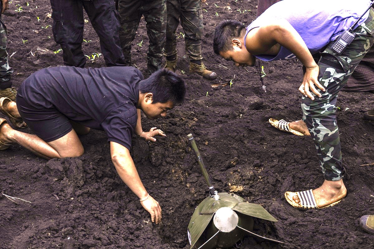 MOBYE, MYANMAR - 2023/06/15: The Karenni National Defense Force-KNDF members are trying to retrieve an unexploded air bomb that fell on a farm. The Myanmar air force has flown 527 airstrikes in the Karenni (also Known as Kayah) region since military coup on February 2021 until the end of June this year, according to a local research group of the Progressive Karenni People's Force (PKPF). (Photo by Sit Htet Aung/SOPA Images/LightRocket via Getty Images)
