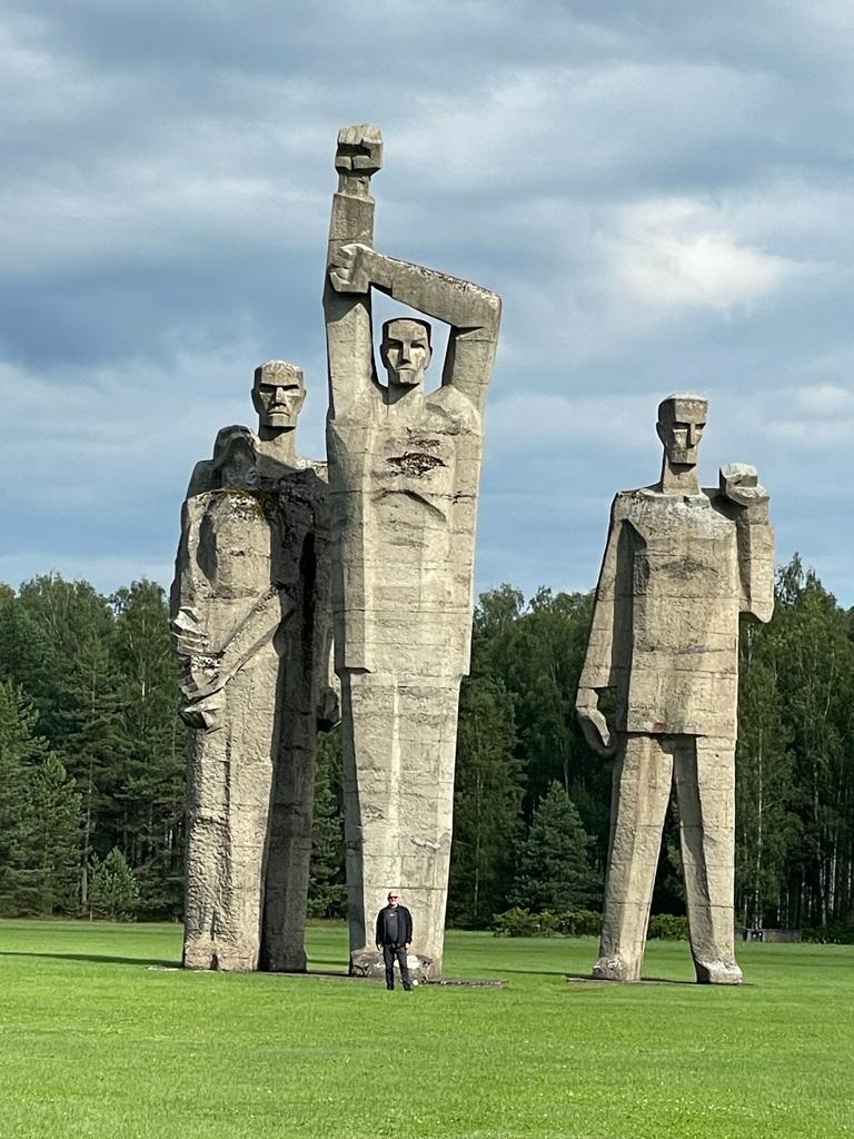 The author stands in front of the Salaspils Soviet Era Memorial on the site of a Nazi labour camp in Latvia (Image courtesy of the author)