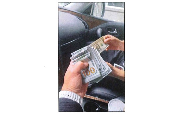 A surveillance photograph reproduced from the indictment, said to show the exchange of cash for the killing (US Justice Department)