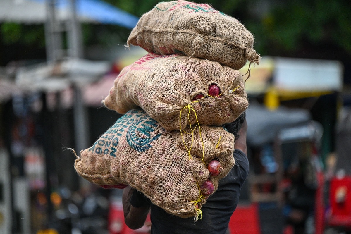 A labourer carries a sack of onions at a market in Colombo on July 4, 2023. Bankrupt Sri Lanka's bearish bourse made a dramatic turnaround on July 4 on the first day of trading since the government unveiled a plan to restructure its huge debt burden. (Photo by Ishara S. KODIKARA / AFP) (Photo by ISHARA S. KODIKARA/AFP via Getty Images)