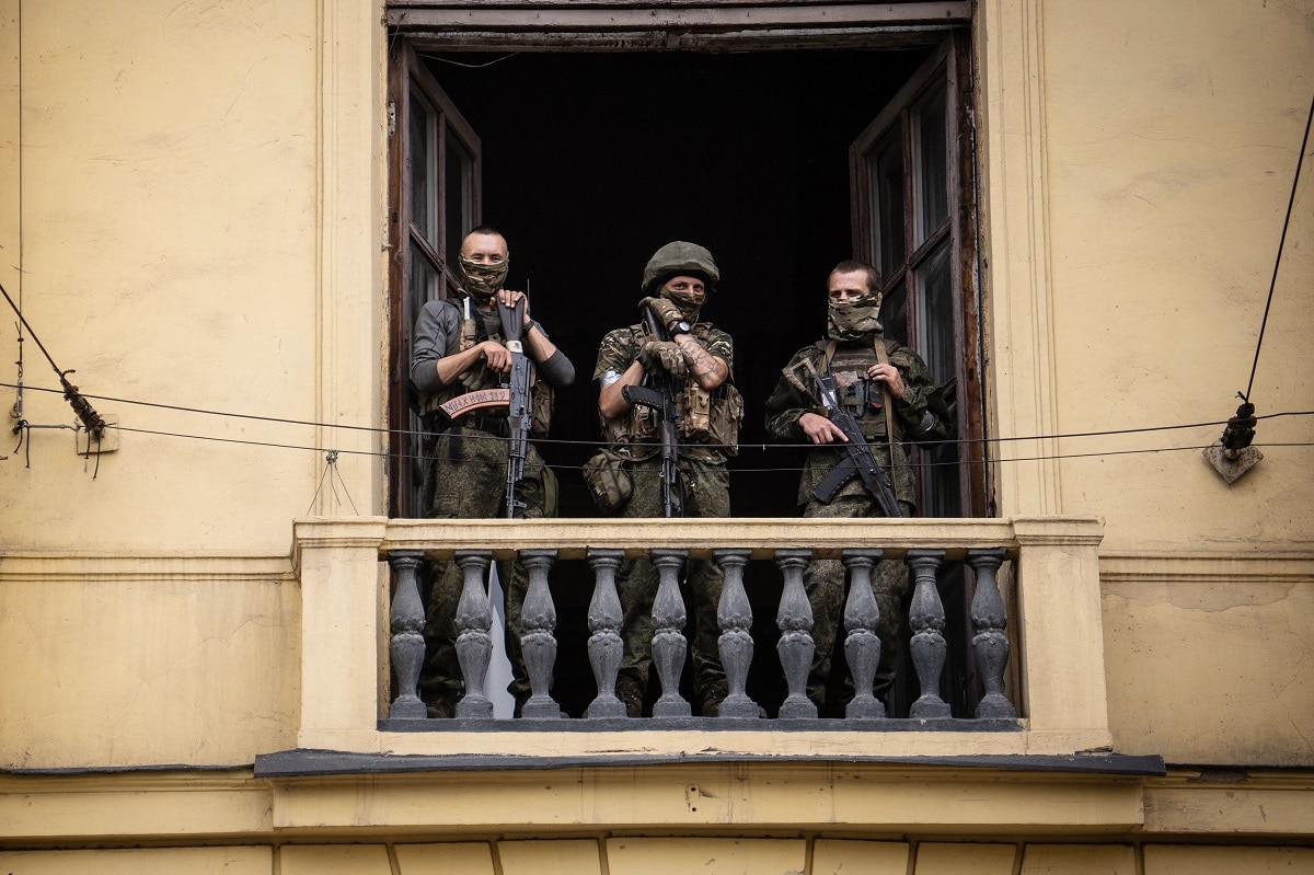 Members of Wagner group stand on the balcony of the circus building in the city of Rostov-on-Don, on June 24, 2023. President Vladimir Putin on June 24, 2023 said an armed mutiny by Wagner mercenaries was a "stab in the back" and that the group's chief Yevgeny Prigozhin had betrayed Russia, as he vowed to punish the dissidents. Prigozhin said his fighters control key military sites in the southern city of Rostov-on-Don. (Photo by Roman ROMOKHOV / AFP) (Photo by ROMAN ROMOKHOV/AFP via Getty Images)