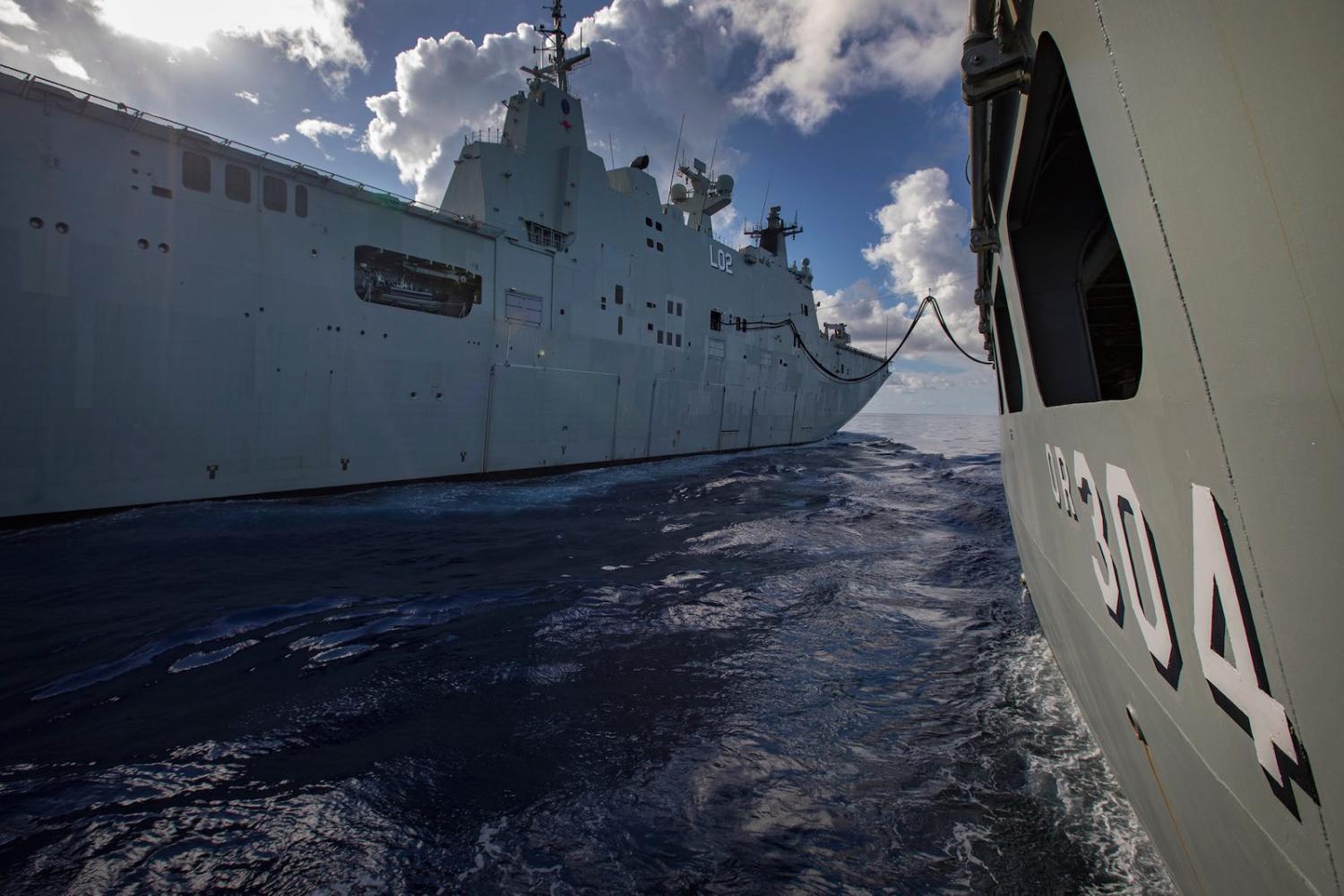 HMAS Canberra connects alongside HMAS Success during replenishment at sea (Photo: Defence Department)