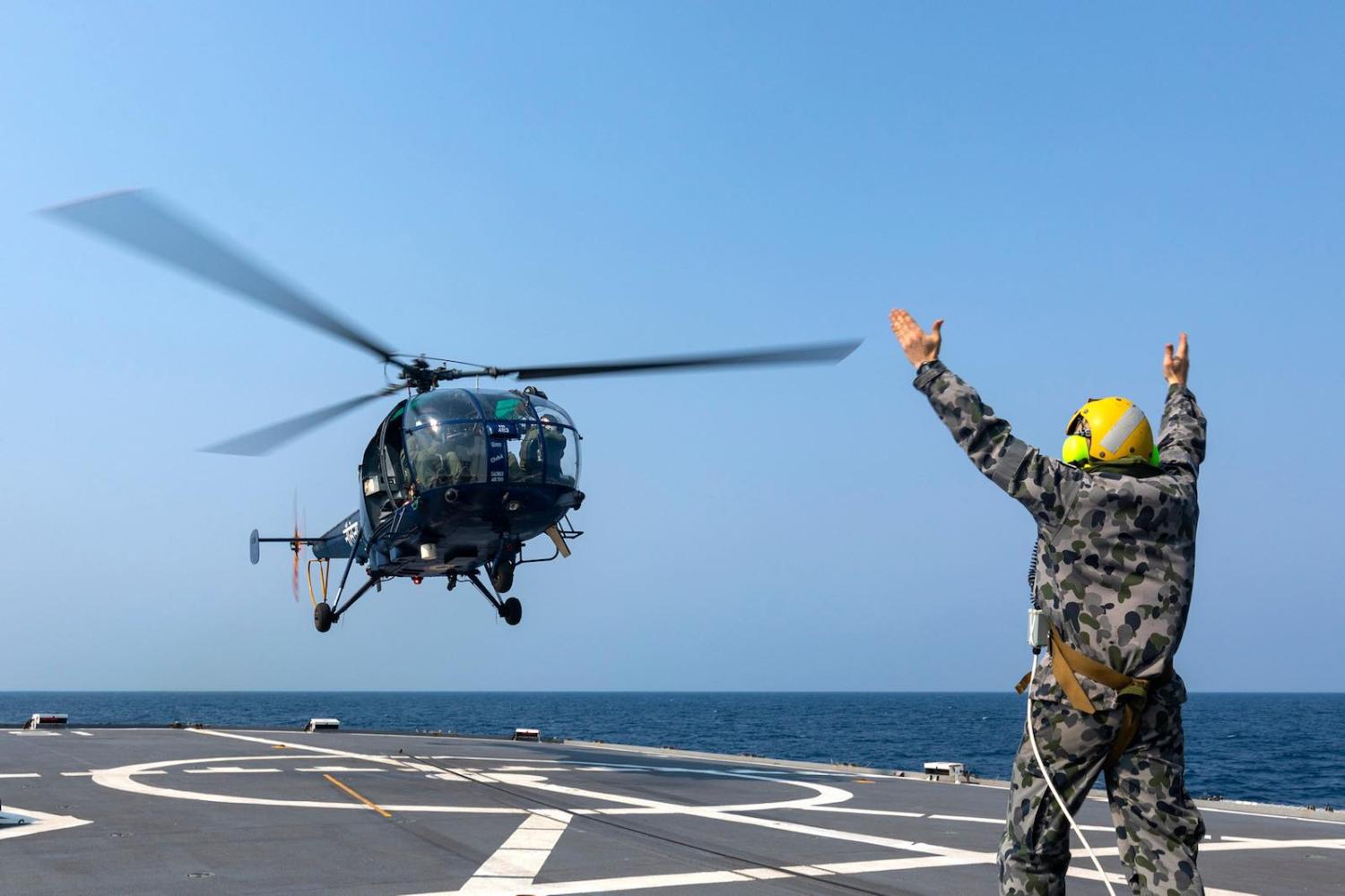 An Indian Navy Chetak helicopter lifts off from HMAS Parramatta during AUSINDEX 2019, in the Bay of Bengal (Australian Defence Force)