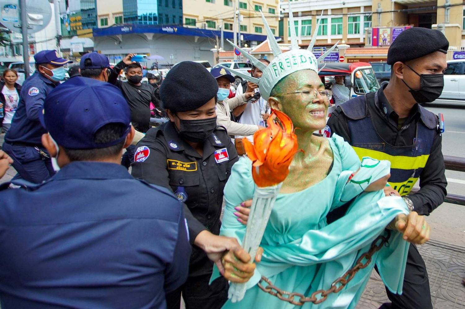 Cambodian-US human rights advocate Theary Seng, dressed as “Lady Liberty”, is arrested by police after being found guilty of treason, Phnom Penh, 14 June 2022 (Samuel/AFP via Getty Images)