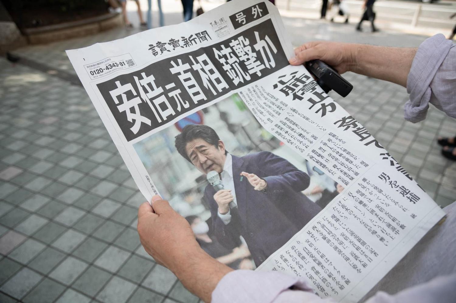 The Yomiuri Shimbun newspaper reports on former Japanese Prime Minister Shinzo Abe, who was shot in Nara, Tokyo, on 8 July (Akio Kon/Bloomberg via Getty Images)