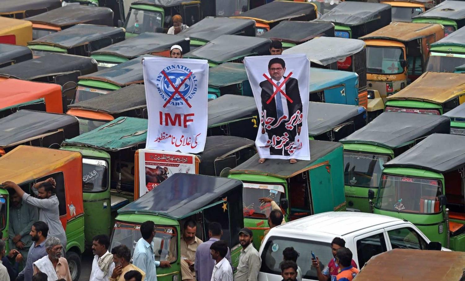 Autorickshaw drivers protest the rising fuel price this month during an anti-government demonstration in Lahore (Photo by Arif Ali/AFP via Getty Images)