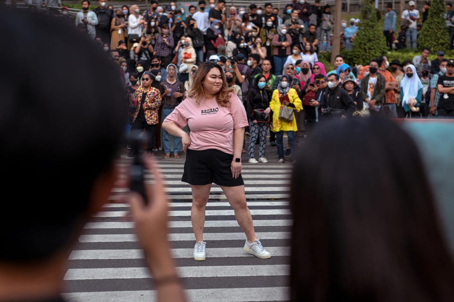Young Indonesians showcase self-styled fashion creations at a pedestrian crossing turned catwalk, Jakarta, 22 June 2022 (Bay Ismoyo/AFP via Getty Images)