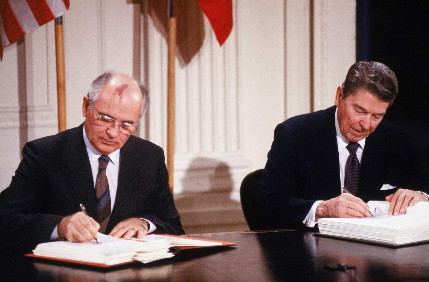 Soviet leader Mikhail Gorbachev and his summit host US President Ronald Reagan signing the Intermediate-Range Nuclear Forces Treaty, 1987 (Dirck Halstead/Getty Images)