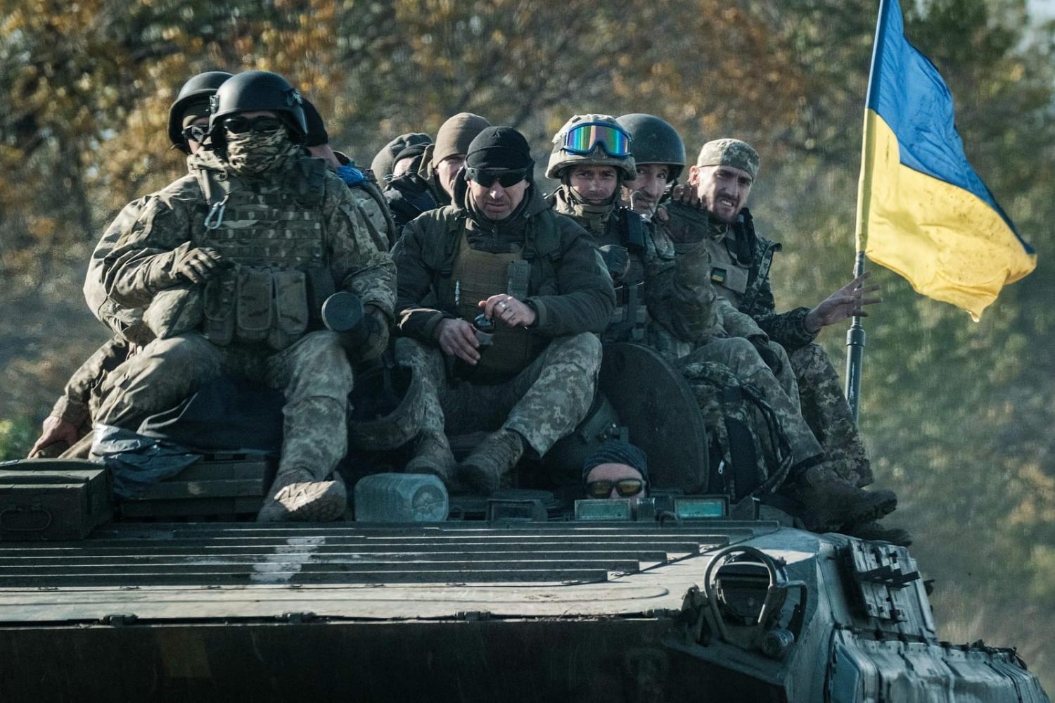 Ukrainian soldiers ride on an armoured vehicle in Novostepanivka, Kharkiv region, 19 September 2022 (Yasuyoshi Chiba/AFP via Getty Images)