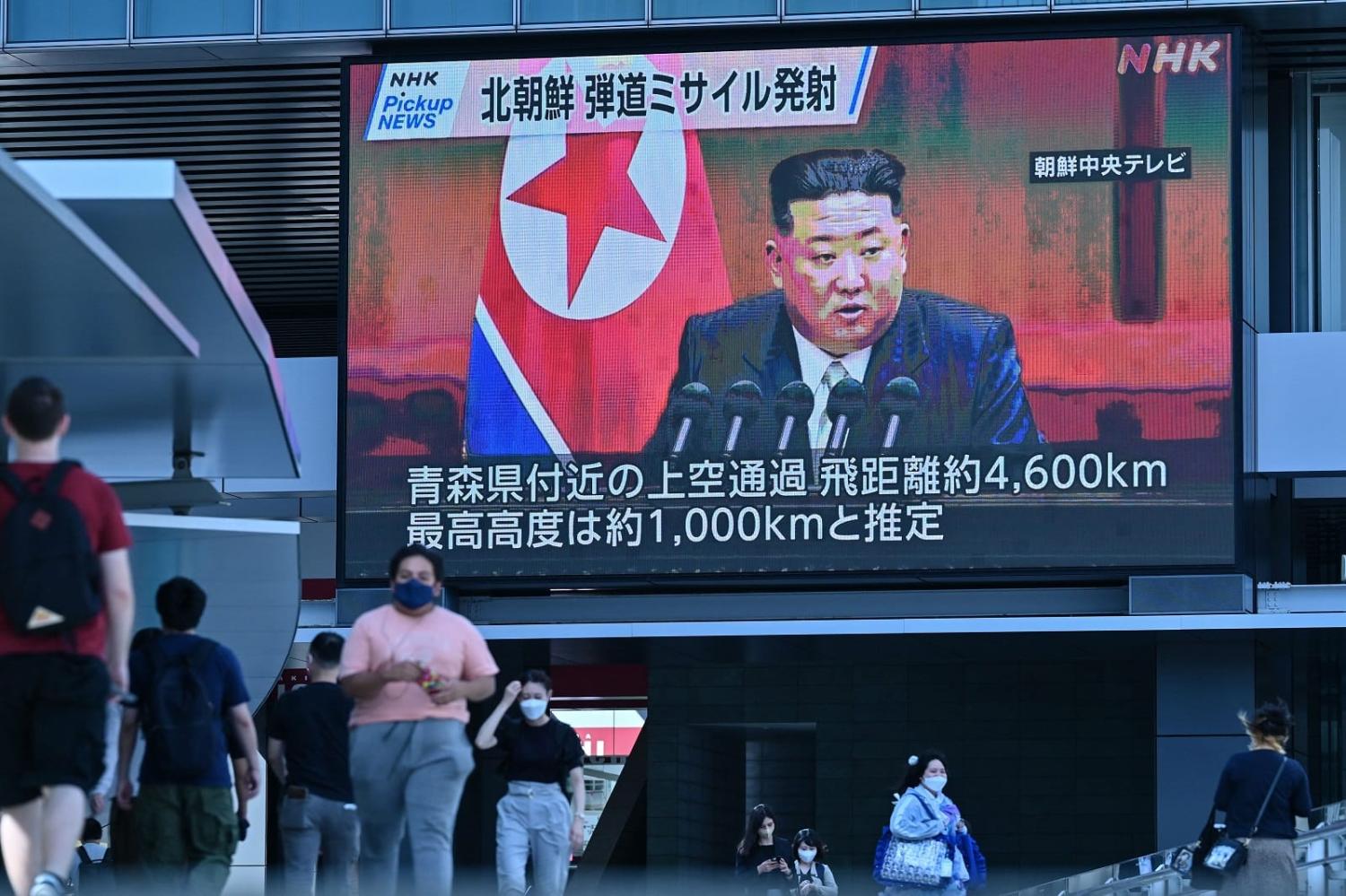 A video screen in Tokyo shows North Korea’s leader Kim Jong-un after Pyongyang launched a missile early in the day, 4 October 2022 (Richard A. Brooks/AFP via Getty Images)