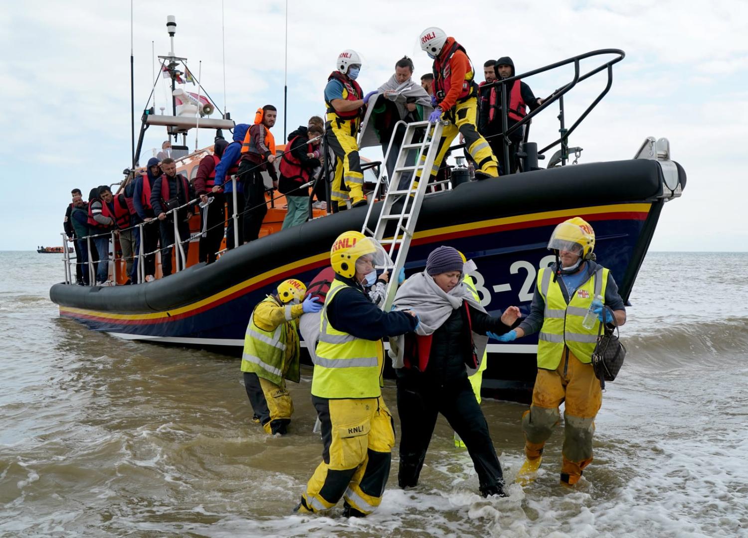 A group of people thought to be migrants are brought in to Dungeness, Kent, after being rescued from a small boat in the English Channel (Gareth Fuller via Getty Images)