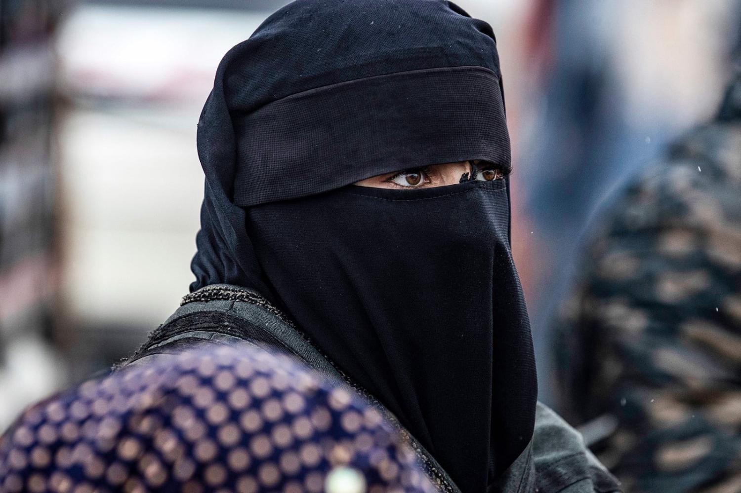 A woman looks on during the release of persons suspected of being related to Islamic State group fighters, al-Hol camp, Syria (Delil Souleiman/AFP via Getty Images)