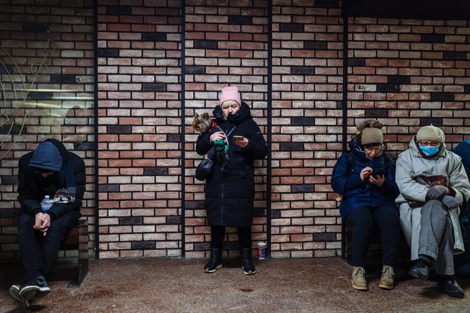 Civilians take shelter in an underground passage during an airstrike alert in the centre of Kyiv on 5 December amid the Russian invasion of Ukraine (Dimitar Dilkoff/AFP via Getty Images)
