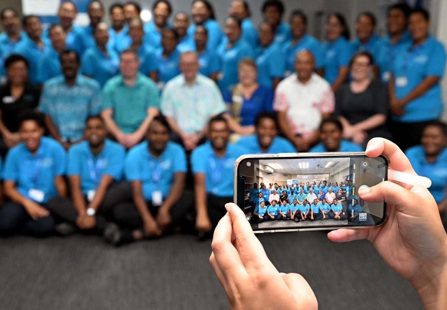 Australian Prime Minister Anthony Albanese poses with staff and students of the Australia Pacific Training Coalition centre after attending the Pacific Islands Forum in Suva on 15 July 2022 (William West/AFP via Getty Images)