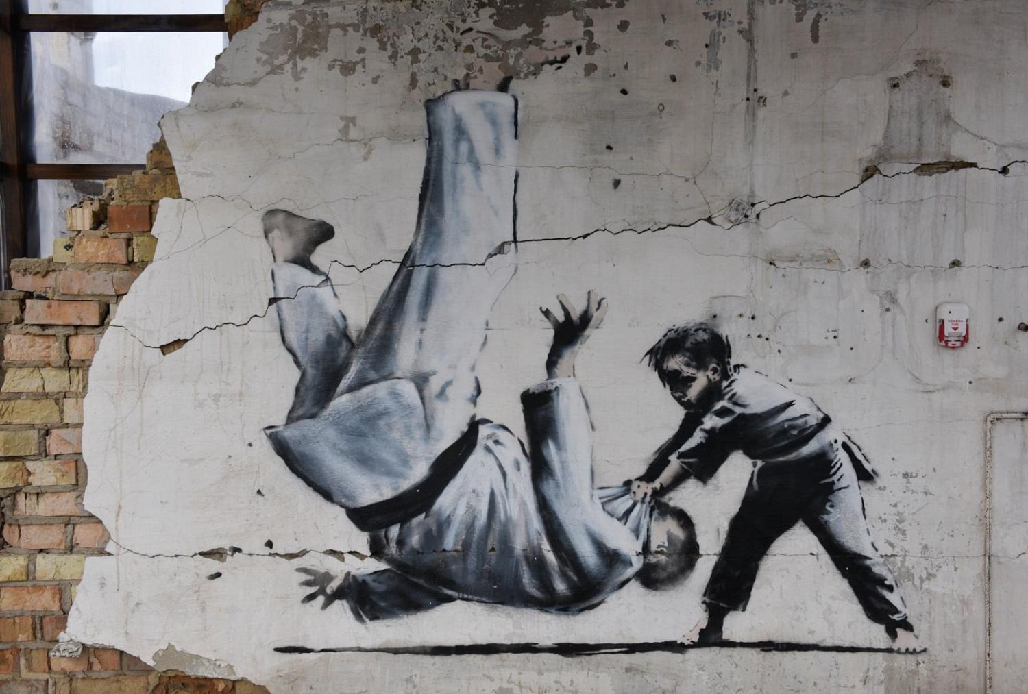 The graffiti work of English artist Banksy on a wall destroyed when the Russian Federation attacked the city of Borodyanka in Ukraine, 26 February 2023 (Maksym Polishchuk/SOPA Images/LightRocket via Getty Images)