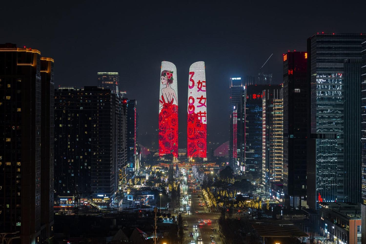 Twin towers in Chengdu, China, are illuminated during a celebration of International Women's Day, 8 March 2022 (Liu Yan/VCG via Getty Images)