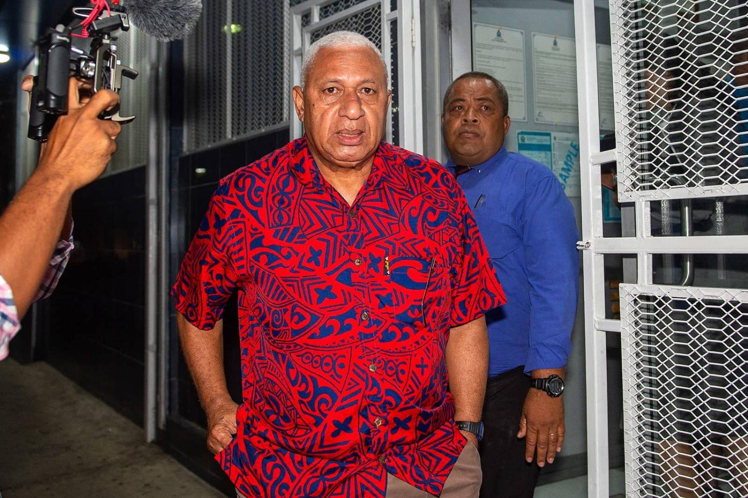 Fiji's former prime minister Frank Bainimarama (C) is taken into the Totogo Police remand centre in Suva on 9 March 2023 (Leon Lord/AFP via Getty Images)